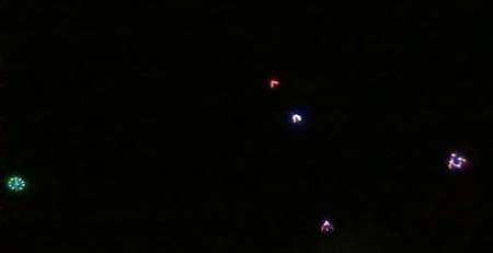 The LED kites are flying above the sky. 