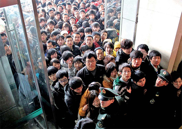 Passengers line up to buy tickets at a railway station in Hefei, capital of Anhui province, on Sunday. The online ticket booking system was made to spare travelers the discomforts of buying tickets at