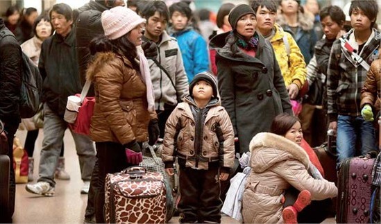 Chinese Spring Festival travelers check train times at a station in Beijing Wednesday. Millions of the country's migrant workers choose this time to return home and reunite with their families.Photo: 