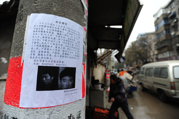 A notice offering 100,000 yuan ($15,800) to anyone who provides information leading to the capture of Zeng Kaigui, suspected to have killed a man on Friday in Nanjing, Jiangsu province, put up in a Na