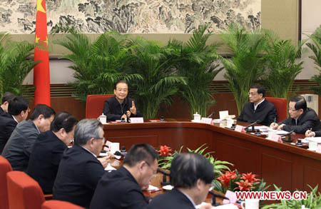 Chinese Premier Wen Jiabao (C) speaks at a meeting on the development program of China's west and the revitalization of the northeast old industrial bases in Beijing, Jan. 9, 2012. (Xinhua/Pang Xinglei)