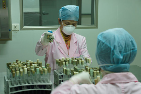 Monitors at the Liuzhou disease prevention and control center examine water samples from various parts of the city on Wednesday. The monitors take samples every few hours to ensure tap water supply to city residents. Lan Lin / for China Daily 