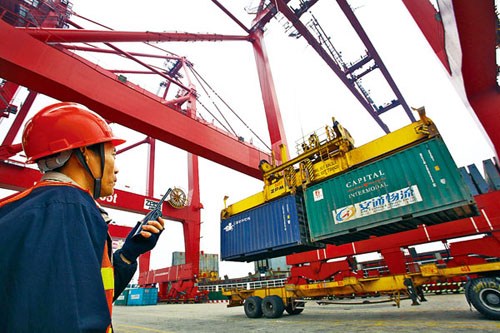 Containers being loaded at a dock in Haikou, capital city of Hainan province. IMF officials say some modest financial support for the Chinese economy is warranted in light of the risk of a global downturn. Provided to China Daily 