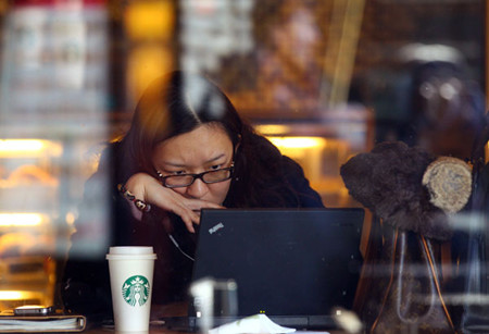 A customer is absorbed in thought at Starbucks in Sanlitun, Beijing, on Tuesday. Zou Hong / China Daily