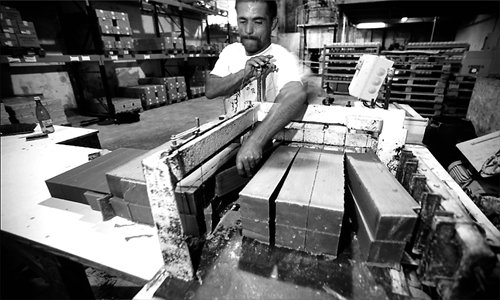 A worker makes traditional soap in France. [Photos: Courtesy of AFS]