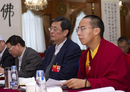 The 11th Panchen Lama Bainqen Erdini Qoigyijabu (R, Front), also a member of the 11th National Committee of the Chinese People's Political Consultative Conference (CPPCC), attends a discussion of the religious circle on the government work report by Premier Wen Jiabao in Beijing, China, March 5, 2012. (Xinhua/Huang Jingwen)