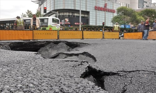 This hole appeared near Shanghai Railway Station last October. It is believed to have been caused by subsidence because of movement in the city's underground water table. Photo: Cai Xianmin/GT