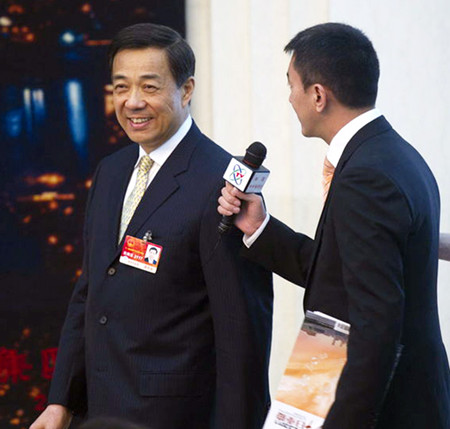 Bo Xilai(left) answered questions to a reporter.