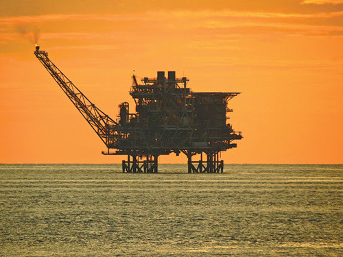 An illegal oil rig spotted in Chinese territorial waters during the China Marine Surveillance Force's third patrol this year on the South China Sea, at sunset. [Photos: Wang Xiaodong / China Daily]