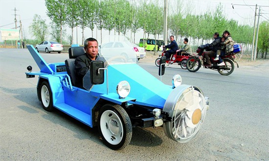 Tang Zhenping, a Tongzhou district farmer, drives the electric car that he built himself. The car topped off at 70 kph in a test drive Tuesday.