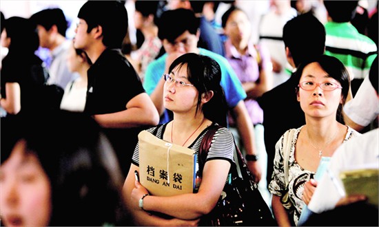 A woman job hunts at a job fair in May 2011 for those who have college education and have served in Beijing's village-level governments. 