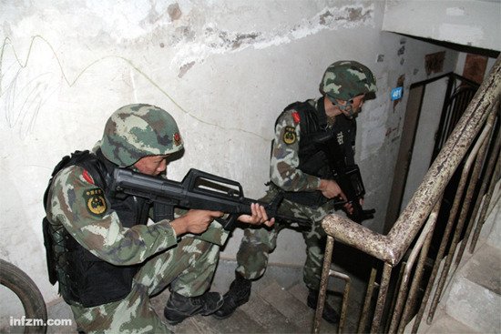 The anti-drug police are waiting for command during a covert operation in Yunnan Province. In recent years, armed drug trafficking has become a growing threat in the Golden Triangle.” 