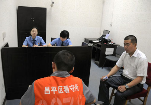 An appropriate adult accompanies a juvenile at Changping prosecuting authority in Beijing in May. Provided to China Daily