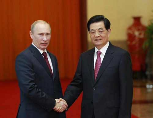 Chinese President Hu Jintao (R) shakes hands with his Russian counterpart Vladimir Putin during a welcoming ceremony in Beijing, capital of China, June 5, 2012. Putin arrived in Beijing on Tuesday to attend the 12th Meeting of the Council of Heads of Member States of the Shanghai Cooperation Organization (SCO). (Xinhua/Ju Peng)