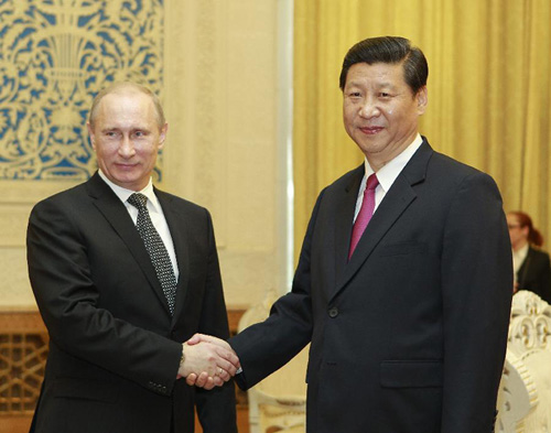 Chinese Vice President Xi Jinping (R) meets with Russian President Vladimir Putin, who came to pay a state visit to China and attend a summit of the Shanghai Cooperation Organization (SCO), at the Great Hall of the People in Beijing, capital of China, Jun