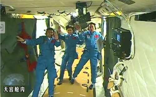 TV grab taken on June 18, 2012 shows Chinese astronauts Jing Haipeng, Liu Wang and Liu Yang at the orbiting Tiangong-1 lab module. (Xinhua)
