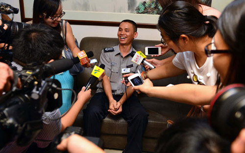 Huang Zhaojing is interviewed by media in Guangzhou, Guangdong province, on Sunday. [For China Daily] 
