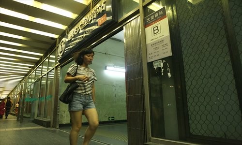 A woman walks out of Dawanglu Subway Station Wednesday.