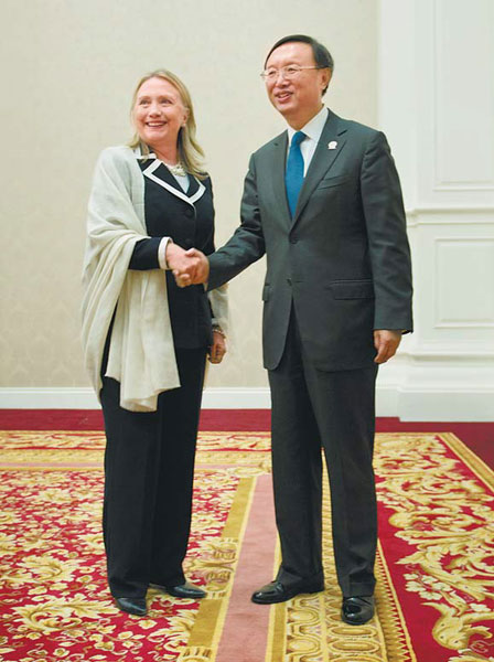 Foreign Minister Yang Jiechi shakes hands with US Secretary of State Hillary Clinton before their talks in Phnom Penh on Thursday. [Photo by Agencies]
