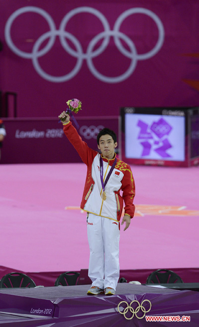 Gold medalist Zou Kai of China poses during victory ceremony of men's floor exercise contest of gymnastics artistic event, at London 2012 Olympic Games in London, Britain, on August 5, 2012. (Xinhua/Qi Heng)