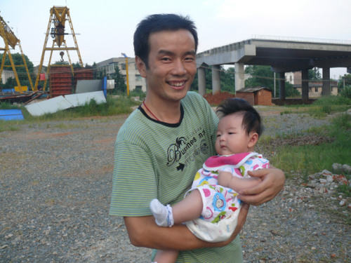 Wei poses with his baby girl. 