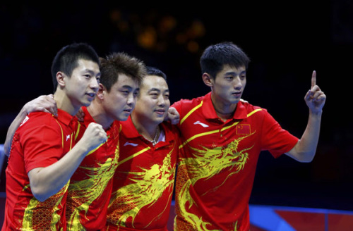 China's Zhang Jike (R) and team mates Wang Hao (2nd L), Ma Long (L) and coach Liu Guoliang celebrate their victory in their men's team gold medal table tennis match against South Korea at the ExCel venue during the London 2012 Olympic Games August 8, 2012