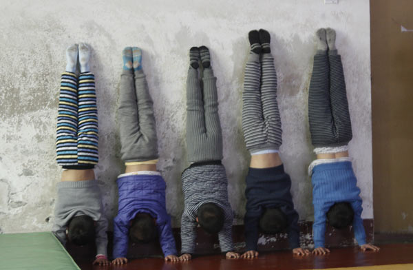 Children practice doing handstands at the Li Xiaoshuang Gymnastics School in Xiantao, Central China's Hubei province.