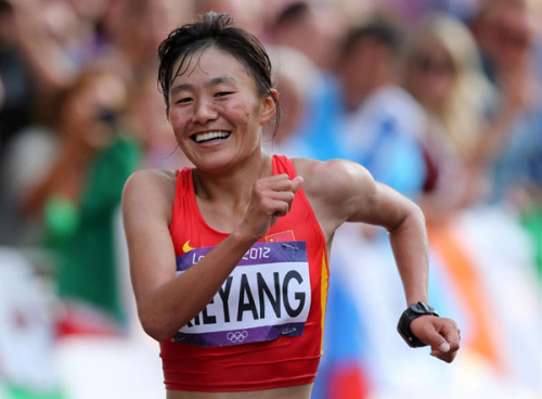 China's Qieyang Shenjie smiles as she finishes third in the women's 20km race walk final at the London 2012 Olympic Games at The Mall August 11, 2012. [Photo/Xinhua]