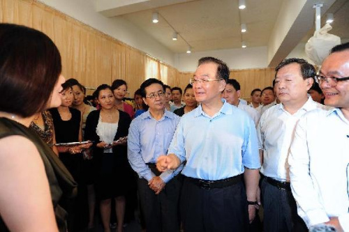 Chinese Premier Wen Jiabao (3rd R, front) visits the Elegant Prosper garment company in Jiaxing, east China's Zhejiang Province, Aug. 15, 2012. Wen made an inspection tour in Zhejiang on Tuesday and Wednesday. (Xinhua/Li Tao)
