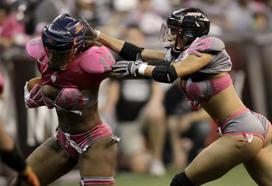 Lingerie Football League's Adrian Purnell (R) from the Eastern Conference battles for the ball with Chrisdell Harris from the Western Conference during an exhibition match in Mexico City May 5, 2012. [Photo/Agencies]