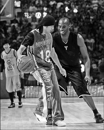 Los Angeles Lakers guard Kobe Bryant (right) plays against Chinese musician Jay Chou on Saturday in Shanghai. The two led teams in a charity game benefitting the Project Hope schools.