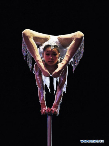 An acrobat of China's Fuyong Acrobatic Art Troupe performs during the Circuba International Circus Festival 2012, at Trompoloco tent, in Havana, capital of Cuba, on Aug. 27, 2012. China won the Grand Prix and a gold medal of the festival. (Xinhua/Joaquin Hernandez)