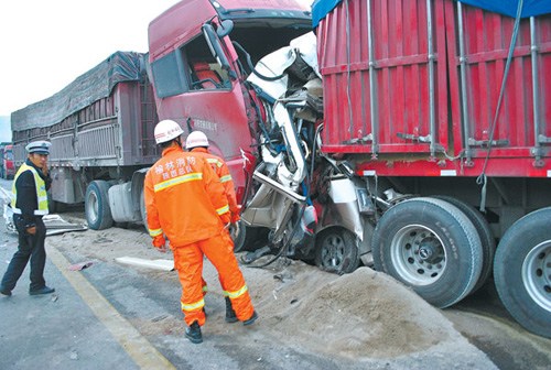 A van, carrying nine people, is concertinaed in Suide, Shaanxi province, on Monday. There were no survivors. Gao Yulong / for China Daily