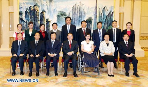 Li Changchun (C front), a Standing Committee member of the Political Bureau of the Communist Party of China (CPC) Central Committee, poses for a photo with Zhang Lili (3rd R front), a teacher who lost her legs while saving two students from an onrushing b