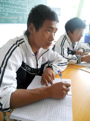 He Runquan (left), a teenager of the Naxi ethnic group, learns Tibetan grammar at the Tibetan High School in the Diqing Tibet autonomous prefecture, Yunnan province. HUANG ZHILING / CHINA DAILY