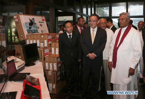 Wu Bangguo (C, front), chairman of the Standing Committee of China's National People's Congress (NPC), presents office supplies to Sri Lanka as he meets with Chamal Rajapaksa (R, front), speaker of the Parliament of Sri Lanka, in Colombo, Sri Lanka, Sept. 17, 2012. (Xinhua/Liu Weibing)