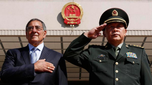 US Secretary of Defense Leon Panetta and Defense Minister Liang Guanglie share a solemn moment as they observe their national anthems at the Bayi Building in Beijing on Tuesday. [Photo/Agencies] 