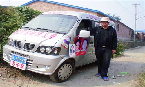 Xiao Chaohua, father of a missing child, stands beside his minivan at Songzhuang, Tongzhou district, last week. Xiao drove from Jiangxi Province to Beijing to draw attention to the plight of trafficked children. Photo: Courtesy of a parent 