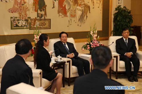 Zhou Yongkang (C), a member of the Standing Committee of the Political Bureau of the Communist Party of China (CPC) Central Committee, attends a symposium held to promote the deeds of a late police officer Hao Wanzhong in Beijing, capital of China, Sept. 28, 2012. Hao, an outstanding police officer in north China's Inner Mongolia Autonomous Region, died on the job at age of 41 in May 2011. (Xinhua/Liu Weibing) 