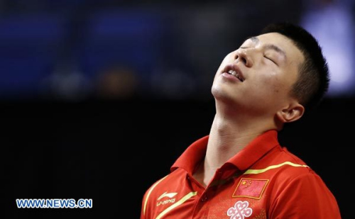 Ma Long of China reacts during the Group A match against Chuang Chih-Yuan of Chinese Taipei during the day 1 of the 2012 Men's Table Tennis World Cup at Echo Arena in Liverpool, Britain on September 28, 2012. Ma lost to Chuang with 0-4. (Xinhua/Wang Lili)