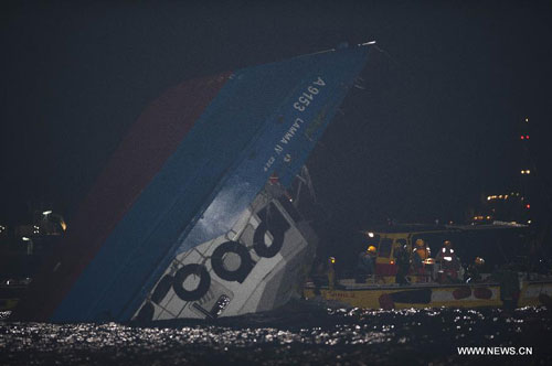 Rescuers get close to a partially-submerged vessel after a collision in Hong Kong, south China, Oct. 2, 2012. At least 25 people were killed, over 100 were injured after two vessels collided on Monday evening off the Lamma Island on the southwest of the Hong Kong Island, the Hong Kong city government said Tuesday. (Xinhua/Lui Siu Wai)  