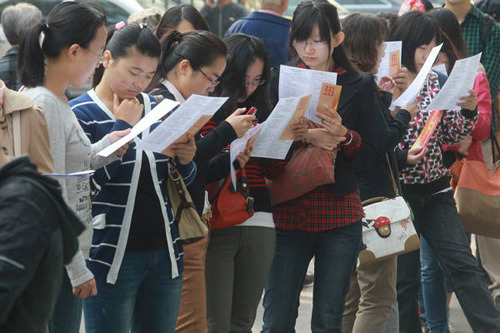 College seniors look for employment opportunities on Thursday at the first job fair in Beijing for students who will graduate next year. Fu Ding / for China Daily