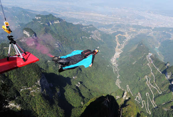 A competitor spreads his wings over Tianmen Mountain in Zhangjiajie, Hunan province, during the first World Wingsuit Championship, Oct 18, 2012. Photo by Yang Huafeng / China News Service