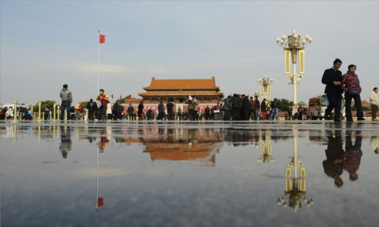Visitors walk at Tiananmen Square in Beijing on Monday. The 18th National Congress of the Communist Party of China will open on November 8 to usher in leaders for the next decade. Photo: AFP 