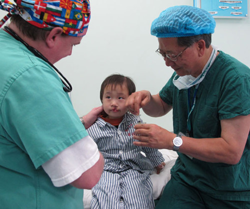 Medical experts check a child with a cleft lip in Zunyi No 1 People's Hospital. Provided to China Daily