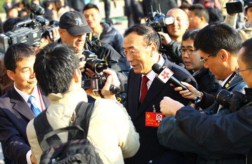 Qiangba Puncog (center), chairman of the Standing Committee of the Tibet People's Congress, speaks with reporters in front of the Great Hall of the People on Thursday in Beijing. ZOU HONG / CHINA DAILY