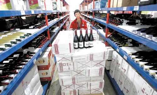 An employee at the warehouse of Beijing Jiuxian E-Commerce Co Ltd, a spirits seller that has decided to take part in the Nov 11 e-commerce promotion. The company sold 10 million yuan ($1.6 million) worth of spirits in last year's event. Zhang Wei / China Daily