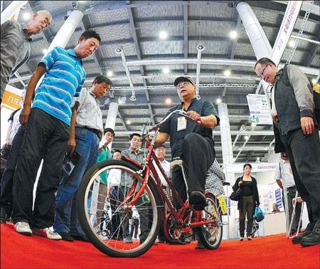 An exhibitor shows visitors how to ride a bicycle specially designed for exercise during the China International Patent Fair 2012 at Dalian World Expo Center, Liaoning province, on Sept 16. Liu Debin / for China Daily