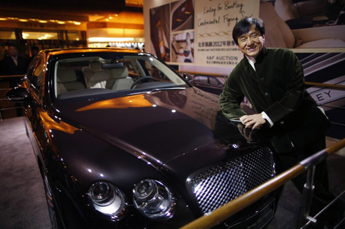 Kung Fu superstar Jackie Chan poses before having his Bentley 666 auctioned for charity in Beijing, November 19, 2012. [Photo/Agencies]