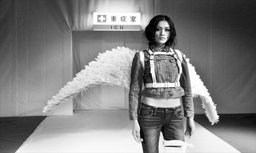 A model poses on a catwalk during a fashion show organized by Greenpeace in Beijing on Tuesday, which exposed toxic residues found in clothing from fashion brands. Photo: courtesy of Greenpeace 